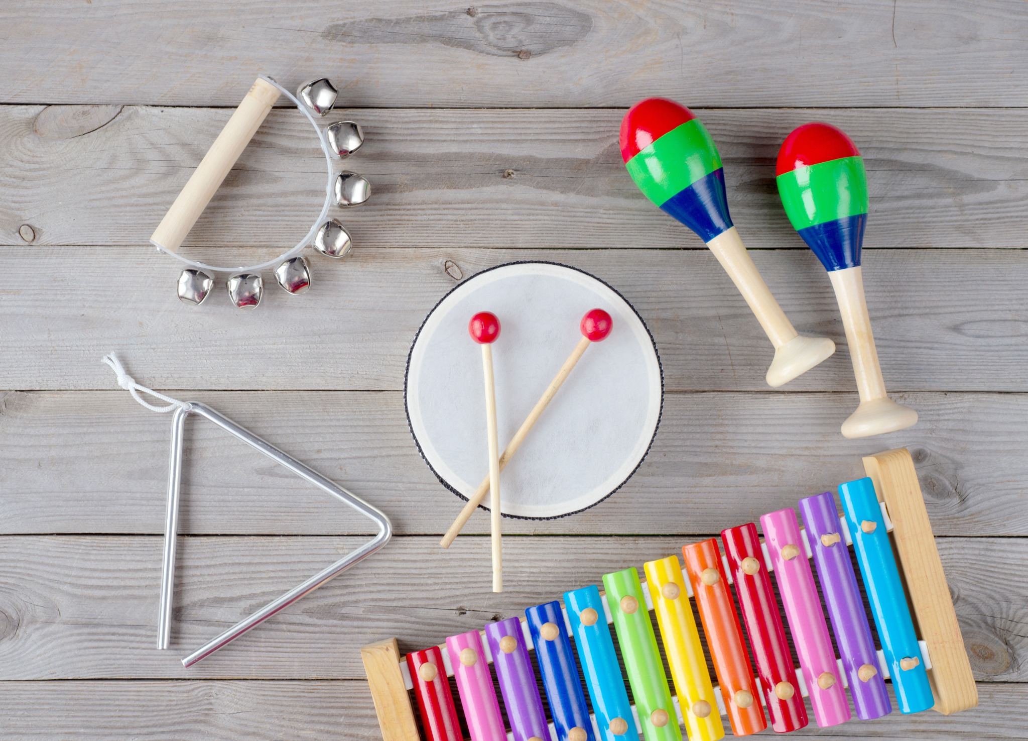 Colourful percussion instruments including maracas, a tambourine and a xylophone